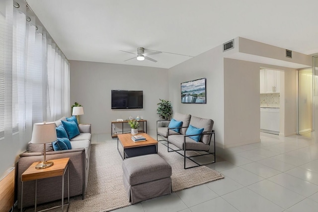 tiled living room with ceiling fan