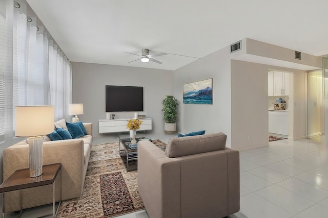 living room featuring ceiling fan and light tile patterned floors