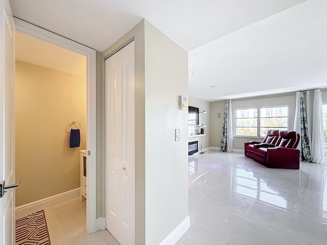 hall featuring light tile patterned flooring