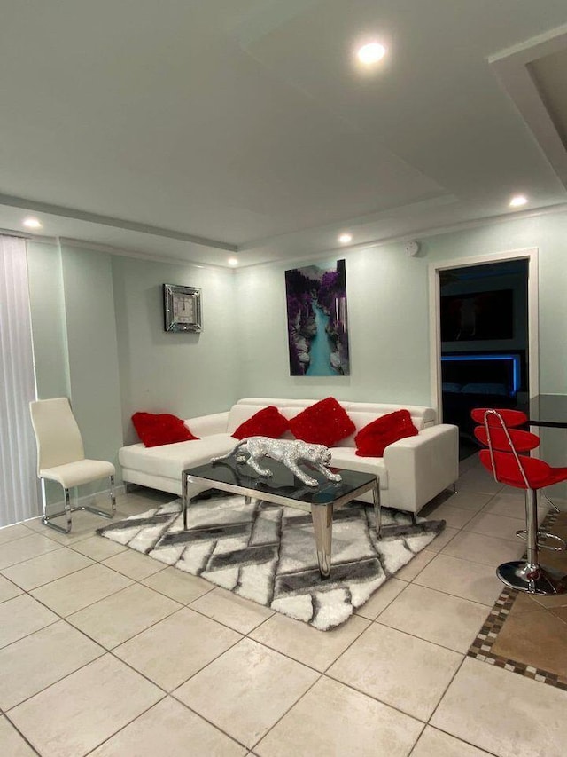 living room featuring light tile patterned floors and an AC wall unit