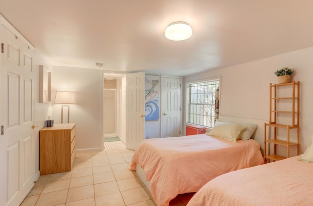 bedroom with light tile patterned floors