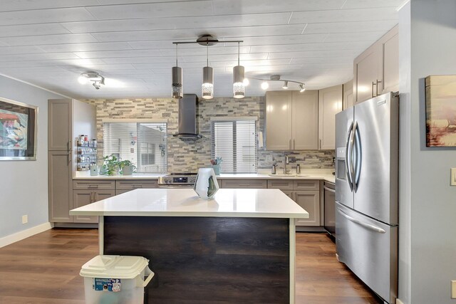 kitchen with backsplash, dark hardwood / wood-style flooring, stainless steel appliances, pendant lighting, and a center island