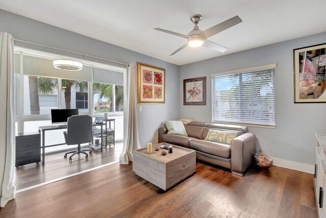 office space featuring ceiling fan and dark hardwood / wood-style floors