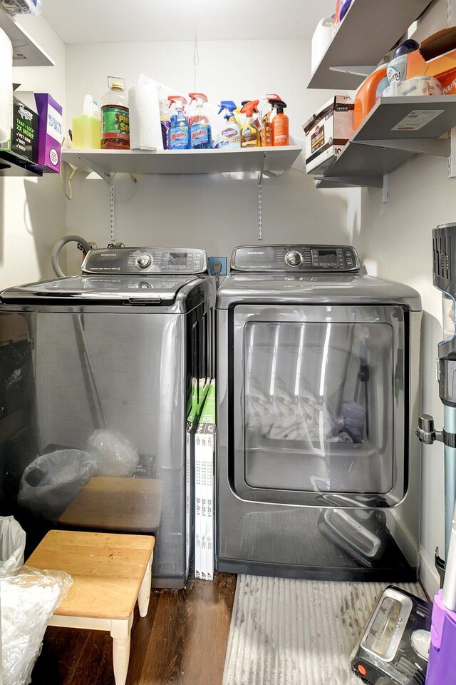 laundry room featuring dark hardwood / wood-style flooring and washer and clothes dryer