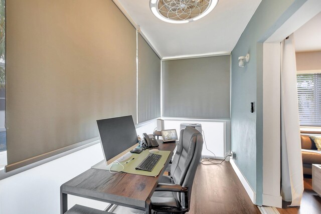 home office with hardwood / wood-style floors