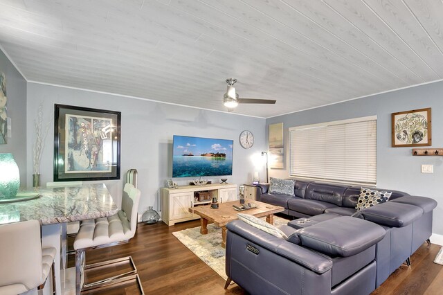 living room featuring ceiling fan and dark wood-type flooring