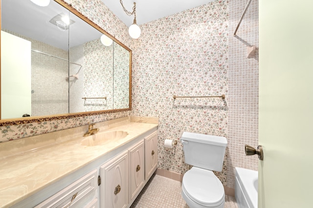 full bathroom with toilet, vanity, tiled shower / bath, and tile patterned flooring