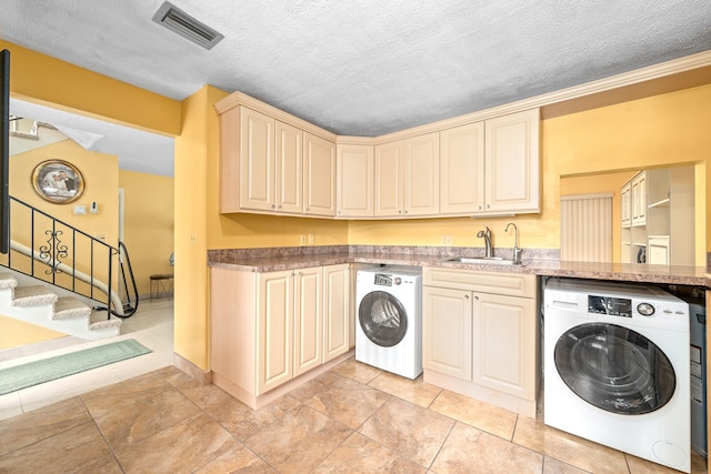 laundry area with washer / clothes dryer, a textured ceiling, and sink