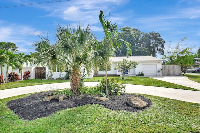 single story home featuring a garage and a front yard