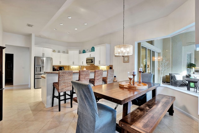 tiled dining space with a wealth of natural light and an inviting chandelier