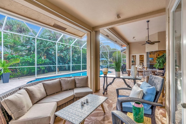 sunroom / solarium featuring lofted ceiling and ceiling fan