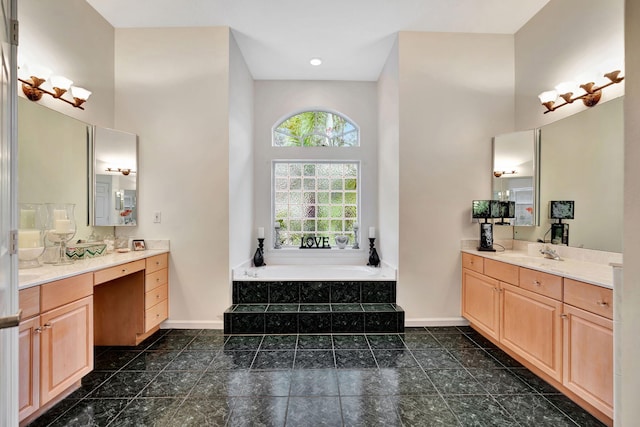 bathroom featuring a high ceiling, vanity, and a tub