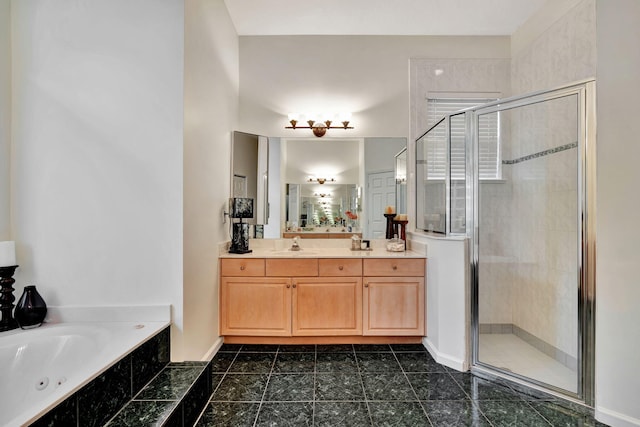 bathroom with vanity and shower with separate bathtub