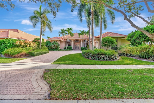 mediterranean / spanish house featuring a front yard