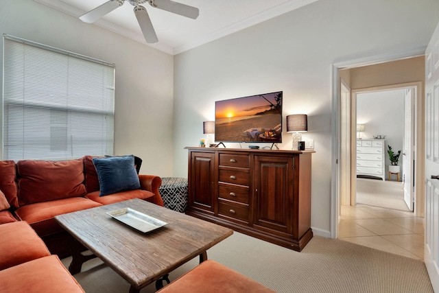 carpeted living room featuring ornamental molding and ceiling fan