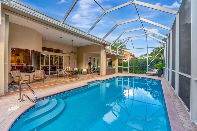 view of swimming pool featuring an outdoor hangout area, ceiling fan, a lanai, and a patio area