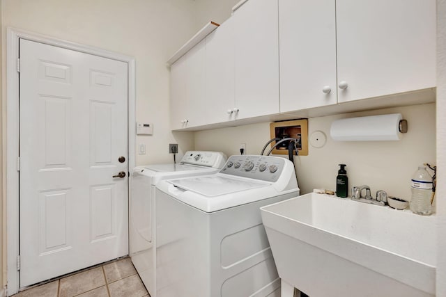 laundry area featuring cabinets, sink, washer and dryer, and light tile patterned flooring