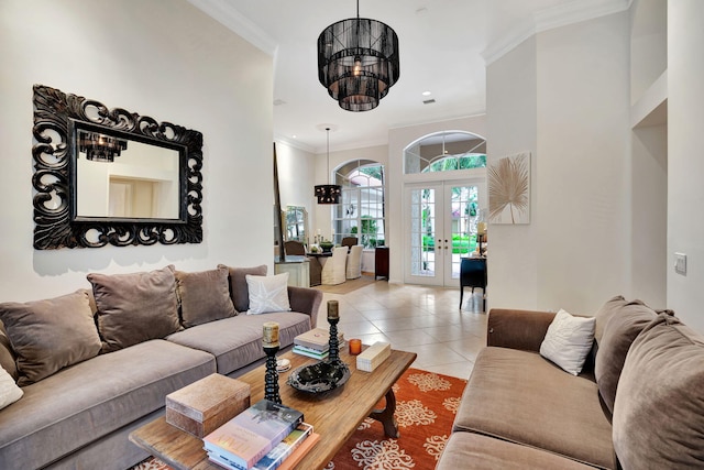 living room featuring a high ceiling, light tile patterned floors, a chandelier, crown molding, and french doors