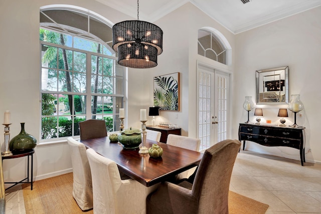 tiled dining room featuring a high ceiling, french doors, a notable chandelier, and ornamental molding