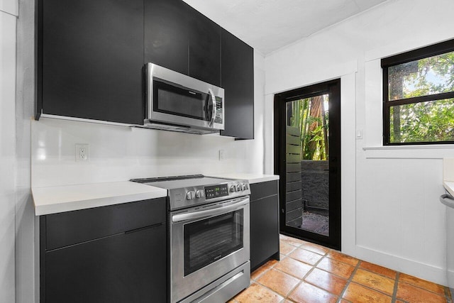 kitchen featuring appliances with stainless steel finishes and light tile patterned floors