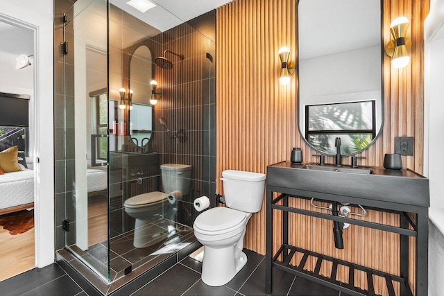 bathroom featuring toilet, an enclosed shower, and tile patterned floors