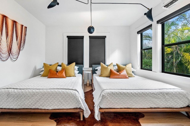 bedroom featuring hardwood / wood-style floors and ceiling fan