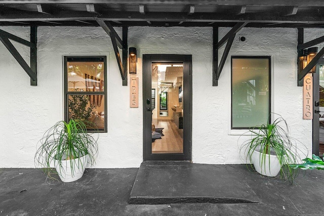 property entrance featuring a pergola