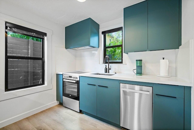 kitchen featuring blue cabinetry, light wood-type flooring, stainless steel appliances, and sink