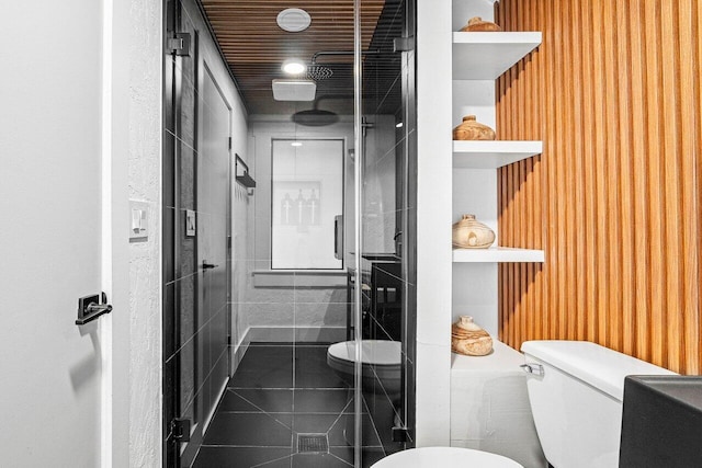 bathroom with walk in shower, tile patterned flooring, and toilet