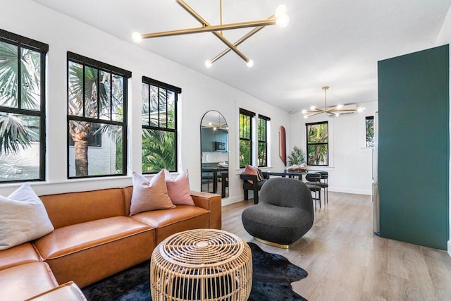 living room with light hardwood / wood-style flooring and an inviting chandelier