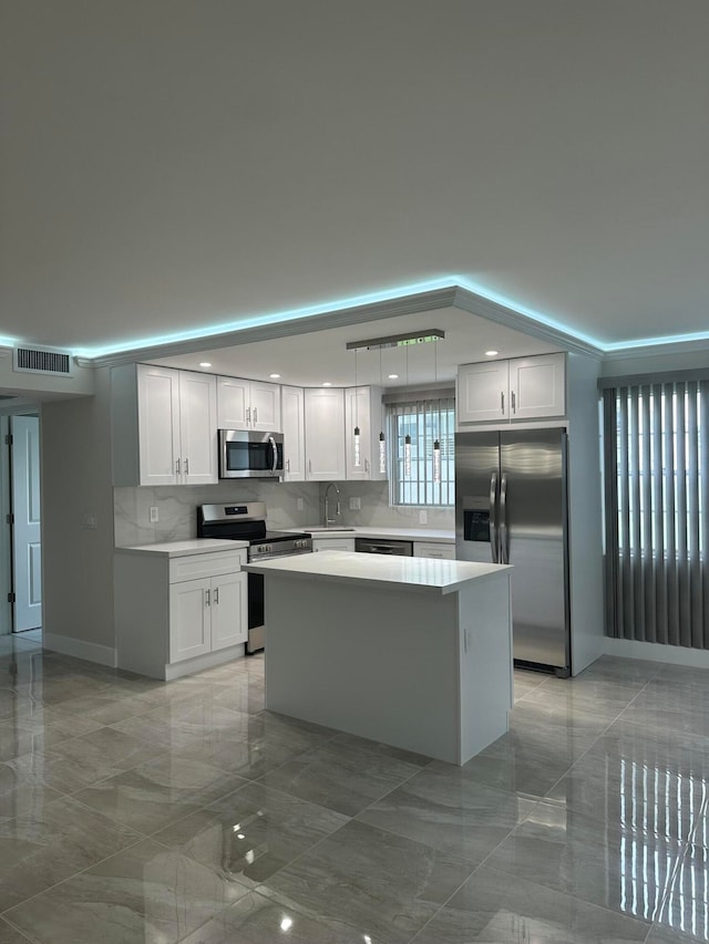 kitchen with white cabinetry, sink, a center island, and stainless steel appliances