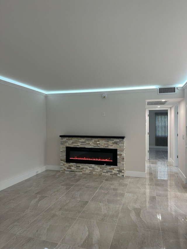 unfurnished living room with a stone fireplace and crown molding