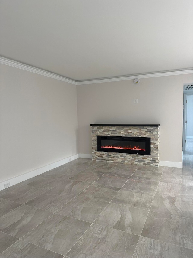 unfurnished living room with a stone fireplace and crown molding