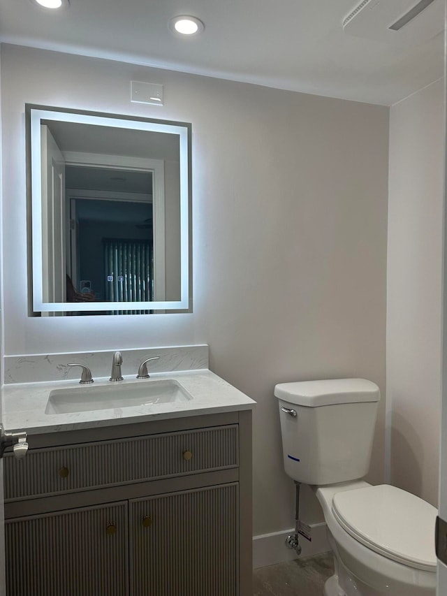 bathroom with vanity and toilet