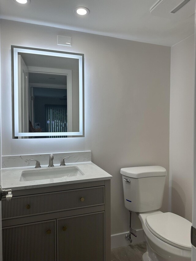 256 Suffolk Unit G, Boca Raton, FL 33434 - half bathroom featuring baseboards, toilet, vanity, and recessed lighting