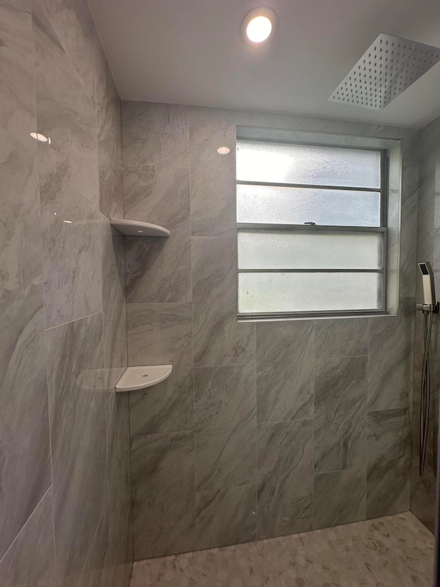 bathroom with tiled shower