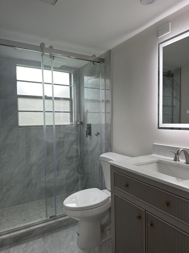 256 Suffolk Unit G, Boca Raton, FL 33434 - bathroom featuring a shower stall, toilet, marble finish flooring, and vanity