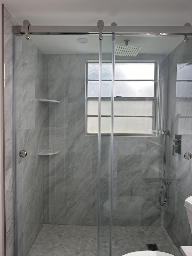 256 Suffolk Unit G, Boca Raton, FL 33434 - bathroom featuring a stall shower and toilet
