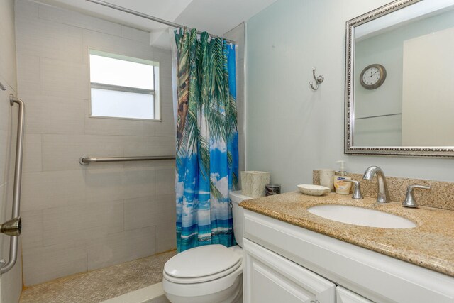 294 Burgundy Unit G, Delray Beach, FL 33484 - full bathroom featuring a tile shower, toilet, and vanity