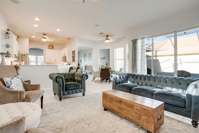 living room with ceiling fan and plenty of natural light