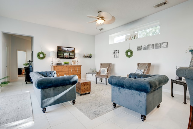 tiled living room with ceiling fan