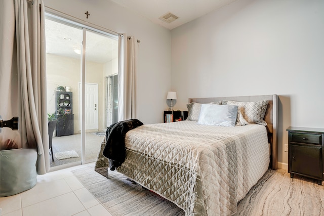 tiled bedroom featuring access to exterior