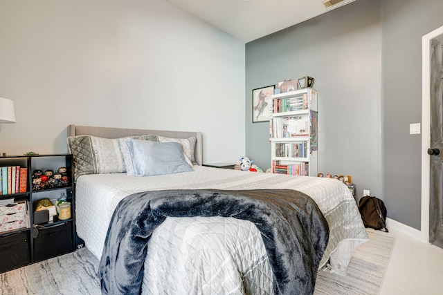 bedroom with light tile patterned floors