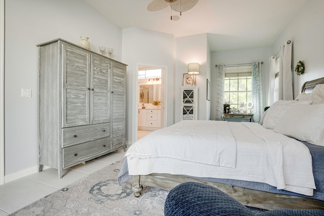 bedroom with ceiling fan, connected bathroom, and light tile patterned floors