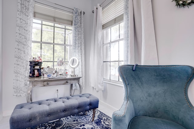 sitting room with plenty of natural light and tile patterned floors