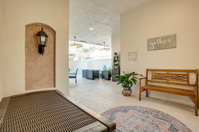 hallway with carpet floors and a textured ceiling