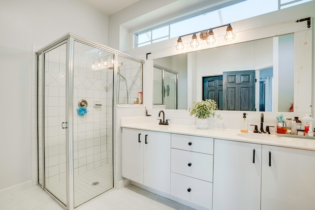 bathroom featuring an enclosed shower, vanity, and tile patterned flooring