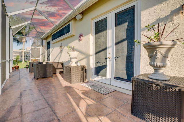 exterior entry at dusk featuring a patio