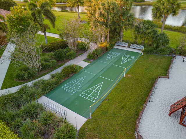 view of community featuring a water view and a yard