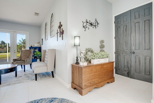 foyer entrance featuring french doors and light tile patterned floors